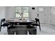 A dining room featuring marble tile floors and a dark table with bench seating at 3799 Sweetbriar Cir, Lithia Springs, GA 30122