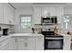 A kitchen features stainless steel appliances and white cabinets with gold hardware at 3799 Sweetbriar Cir, Lithia Springs, GA 30122
