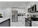 A kitchen features stainless steel appliances and white cabinets with gold hardware at 3799 Sweetbriar Cir, Lithia Springs, GA 30122