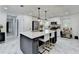 A kitchen features an island with seating, marble tile floors, and stainless steel appliances at 3799 Sweetbriar Cir, Lithia Springs, GA 30122