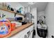 Bright laundry room with storage shelves and modern washer/dryer at 3799 Sweetbriar Cir, Lithia Springs, GA 30122