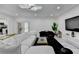 Inviting living room featuring modern decor, a large white sofa, and contemporary accent pieces at 3799 Sweetbriar Cir, Lithia Springs, GA 30122