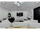 Bright open living room featuring sleek furniture, modern lighting, and a large TV at 3799 Sweetbriar Cir, Lithia Springs, GA 30122