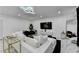 Staged modern living room with white sofa, a decorative mirror, and marble floors at 3799 Sweetbriar Cir, Lithia Springs, GA 30122