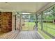 Bright sunroom with a brick wall and views of the backyard at 3799 Sweetbriar Cir, Lithia Springs, GA 30122