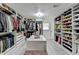 Expansive walk-in closet with custom storage, shelving, and dressing area at 3799 Sweetbriar Cir, Lithia Springs, GA 30122