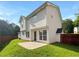 Home's backyard with a concrete patio, lawn, and wood fence provides privacy at 4311 Marci St, Snellville, GA 30039