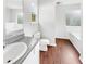 Well-lit bathroom with a soaking tub and wood-look flooring at 4311 Marci St, Snellville, GA 30039