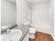 Bright bathroom featuring a shower-tub combo, modern toilet, and vanity at 4311 Marci St, Snellville, GA 30039