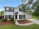 Charming two-story home with black shutters, a manicured lawn, and a two-car garage at 4311 Marci St, Snellville, GA 30039