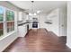 Bright kitchen featuring white cabinets, modern appliances, and new hardwood flooring at 4311 Marci St, Snellville, GA 30039
