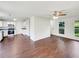 Open-concept living area with updated floors leading into a kitchen with white cabinets at 4311 Marci St, Snellville, GA 30039
