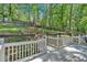 View of the lush backyard featuring a retaining wall with stone accents, lush greenery, and vibrant flowers at 510 Watergate Ct, Roswell, GA 30076