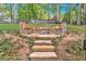 Stone seating area on the property, including steps and a curved stone bench at 510 Watergate Ct, Roswell, GA 30076