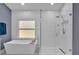 Modern bathroom with white subway tile, standalone tub, glass enclosed shower, and blue accent walls at 510 Watergate Ct, Roswell, GA 30076