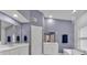 Stylish bathroom with double vanity, modern lighting, mirrors, white cabinets, and separate glass shower at 510 Watergate Ct, Roswell, GA 30076