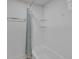 Bright white tiled shower with glass shelves and blue shower curtain at 510 Watergate Ct, Roswell, GA 30076