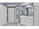 Well-lit bathroom featuring a double vanity, white cabinets, and tile floors with glass enclosed shower at 510 Watergate Ct, Roswell, GA 30076