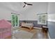 Well-lit bedroom featuring a small bed, hardwood floors, a desk, and a play tent by the window at 510 Watergate Ct, Roswell, GA 30076