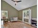 Cozy Bedroom with hardwood floors, ceiling fan, a rocking chair, and a crib with a cute blanket at 510 Watergate Ct, Roswell, GA 30076