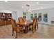 Spacious dining room with a large wooden table, hardwood floors, and access to the outdoors at 510 Watergate Ct, Roswell, GA 30076