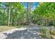 Long driveway leading up to the home surrounded by a forest of trees at 510 Watergate Ct, Roswell, GA 30076