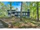 Beautiful two-story home nestled on a wooded lot, featuring dark siding and surrounded by trees at 510 Watergate Ct, Roswell, GA 30076