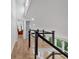 Bright hallway featuring modern railings, hardwood floors, and large windows overlooking the outdoors at 510 Watergate Ct, Roswell, GA 30076