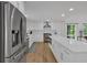 Bright kitchen with white cabinets, an island, stainless steel appliances, and hardwood floors at 510 Watergate Ct, Roswell, GA 30076