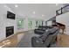 Bright living room with a fireplace, hardwood floors, a leather sofa, and large windows at 510 Watergate Ct, Roswell, GA 30076