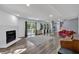Spacious living room features wood floors, fireplace, and large windows with views of the outdoors at 510 Watergate Ct, Roswell, GA 30076