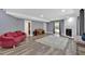 Open-plan living area with a fireplace, light-grey walls and hardwood flooring complemented by a bright-colored couch at 510 Watergate Ct, Roswell, GA 30076