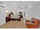 Bright bedroom with hardwood floors, wooden bed set, sitting area, ceiling fan, and large windows at 510 Watergate Ct, Roswell, GA 30076