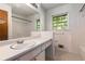 Bathroom featuring white tile, single vanity and a window at 2386 Springrun Way, Decatur, GA 30032