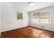 Bedroom featuring hardwood floors and natural light from two windows at 2386 Springrun Way, Decatur, GA 30032