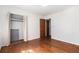 Bedroom with wood floors featuring bi-fold closet doors and passage to another room at 2386 Springrun Way, Decatur, GA 30032