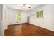 Bright bedroom features two windows, ceiling fan, and hardwood floors at 2386 Springrun Way, Decatur, GA 30032