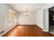 Hardwood dining room illuminated by a chandelier and natural light at 2386 Springrun Way, Decatur, GA 30032