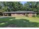 Charming single story brick home featuring a covered carport and lush green lawn at 2386 Springrun Way, Decatur, GA 30032