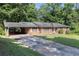 Single-story brick home with a covered carport and a lengthy driveway at 2386 Springrun Way, Decatur, GA 30032