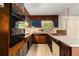 Kitchen features wood cabinets with blue accents and black appliances at 2386 Springrun Way, Decatur, GA 30032