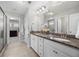 Bathroom featuring double vanity with granite countertop, white cabinets, and tile floor at 307 Cochin Dr, Woodstock, GA 30188