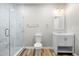 Bathroom features a marble-walled glass shower, a white vanity, and modern fixtures at 307 Cochin Dr, Woodstock, GA 30188