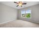 Bright bedroom showcasing a large window and ceiling fan at 307 Cochin Dr, Woodstock, GA 30188
