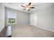 Neutral bedroom featuring carpet floors, a ceiling fan, and natural light from the window at 307 Cochin Dr, Woodstock, GA 30188