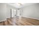 Bright bedroom boasts wood-look floors, neutral walls, and an ensuite bathroom with a large doorway at 307 Cochin Dr, Woodstock, GA 30188