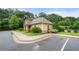 Community clubhouse is surrounded by lush landscaping with the pool nearby at 307 Cochin Dr, Woodstock, GA 30188