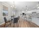 Open kitchen with granite island, stainless appliances, and a dining area with views through large windows at 307 Cochin Dr, Woodstock, GA 30188