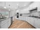 Well-lit kitchen with white cabinets, stainless steel appliances, subway tile backsplash, and a granite countertop island at 307 Cochin Dr, Woodstock, GA 30188
