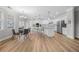 Open concept featuring a kitchen with stainless appliances and a dining area with chairs near large windows at 307 Cochin Dr, Woodstock, GA 30188